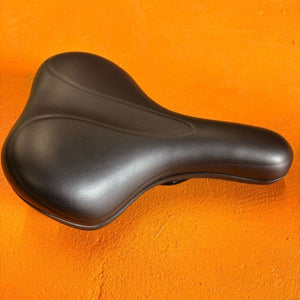 Black city-style eBike seat with ergonomic design and padded surface, shown from a side angle against a white background.