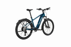 Side view of the Velotric Summit 2 eBike in a mountain landscape, showcasing its sturdy frame, suspension fork, and all-terrain tires.