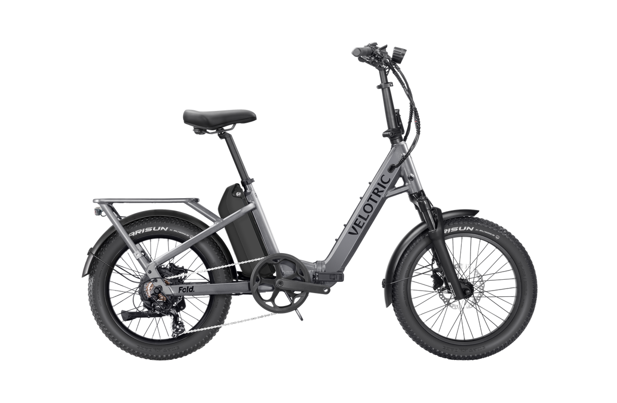 Velotric Fold 1 Plus electric bike in Stone Gray, shown folded for compact storage.