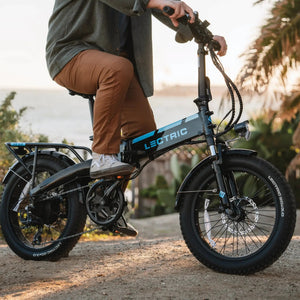 A black Lectric XP 3.0 folding fat tire eBike with a step-over frame, 500W motor, and commuter-friendly design, shown in a side profile with thick tires and compact folding structure.