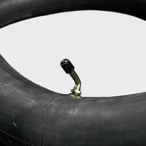 A 20x4.5/5.0-406 eBike inner tube from Tire Co. displayed coiled with a visible valve stem, set against a plain background.
