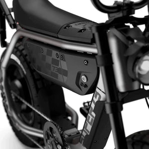 Side view of the Super73 MZFT eMOTO eBike in a showroom, highlighting its rugged frame, thick tires, and minimalist design.