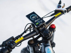 Digital display on a bicycle handlebar with a white background