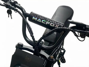 A black Macfox universal eBike bar pad attached to handlebars, displaying the Macfox logo in white.