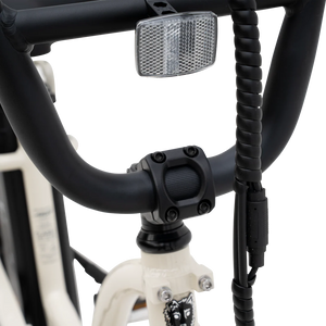 Side view of the Murf Higgs ST eBike in a neutral setting, showcasing its step-through frame, wide tires, and minimalist design.