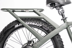 Side view of a QuietKat Ranger AWD 750w Step Over eBike with 26x4.5 fat tires, showcasing its rugged electric mountain bike design against a plain background.