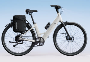 Side view of the Urtopia Carbon 1 Step Thru eBike in creme color, showcasing its lightweight carbon frame, step-through design, and sleek modern styling against a plain background.