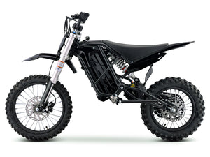 Side view of the eMOTO Stomp Ebox V3 60 electric dirt bike, showcasing its frame, wheels, and suspension system.