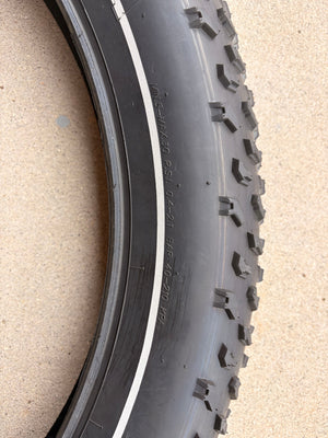 A 26x4 Kenda Krusade fat tire for eBikes with a reflective sidewall, shown in a product image.