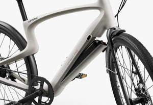 Side view of the Urtopia Carbon Classic eBike in creme color, showcasing its lightweight carbon frame, sleek design, and integrated components against a plain background.