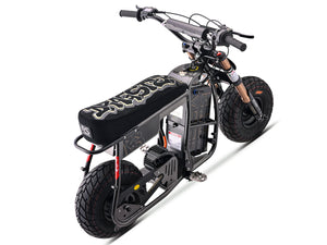 Side view of the eMOTO Stomp Ebox Dragster RS electric dirt bike, showcasing its black and green frame, knobby tires, and sporty design against a plain background.