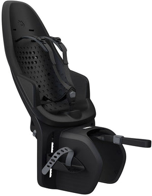 Thule Yepp Maxi 2 child bike seat mounted on a bicycle, featuring a high backrest, adjustable footrests, and a secure harness system.