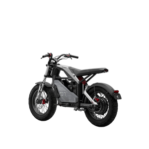 Side view of the eMOTO Segway Xyber electric bike parked outdoors, showcasing its rugged tires, sturdy frame, and modern design features.