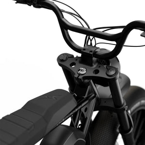 Side view of the Super73 S2 SE electric bike in black, showcasing its thick tires, elongated seat, and minimalist frame design against a plain background.