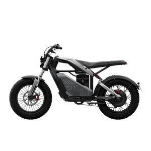 Side view of the eMOTO Segway Xyber electric bike in an outdoor setting, showcasing its rugged tires, sturdy frame, and modern design features.