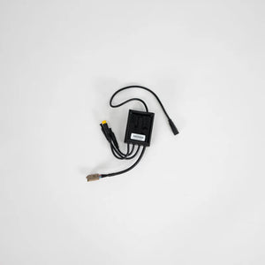 Product image of the eBike Converter - Super73 DCDC Converter Version 1, showing a compact electronic module with wiring connectors and labeled components.