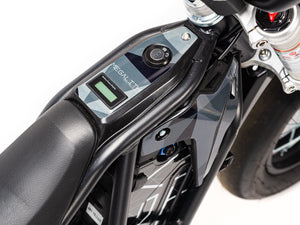 Stomp Ebox Megalith Graphics Kit displayed on a dirt bike, showcasing bold geometric patterns in black, white, and neon yellow with the Stomp logo on the side panels.