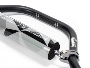 Stomp Ebox Megalith Pitspeed 7075 handlebar, close-up view showing black anodized finish, ergonomic bends, and laser-etched branding on the bar.