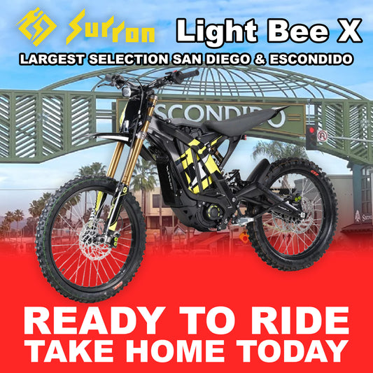 Black Sur-Ron Light Bee X eMOTO electric bike, model R2R, side view, outdoors.