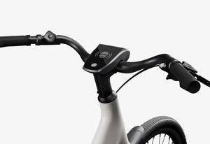 Side view of the Urtopia Carbon 1 Step Thru eBike in a modern setting, showcasing its lightweight carbon frame, step-through design, and integrated display.