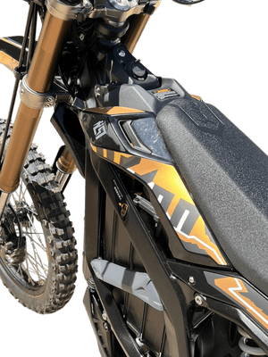 Side view of a 2025 Surron Ultra Bee 21kW electric dirt bike in black and yellow, displayed on a white background.