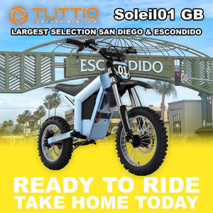 Electric motorcycle parked outdoors in sunlight, featuring a modern design with a matte finish and visible branding.