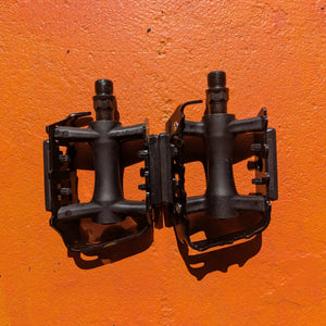 A pair of metal bicycle pedals in Style 7, featuring a sleek, modern design with a textured surface for grip and a silver finish.