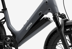 Side view of the Urtopia Carbon Joy eBike in charcoal gray, showcasing its sleek carbon fiber frame, integrated battery, and minimalist design against a plain background.