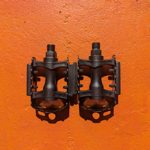 A pair of metal bicycle pedals in Style 5 design, featuring a sleek, durable construction with textured surfaces for improved grip.