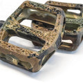 Green nylon bicycle pedal with a camouflage pattern, shown from an angled side view.