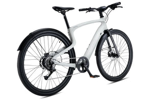 Side view of the Urtopia Carbon 1 Pro eBike in creme color, showcasing its lightweight carbon frame, integrated display, and sleek modern design against a plain background.