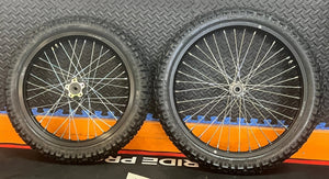 Product image of the eMOTO Surron eMoto Wheel Set featuring Shinko 244 Dual Sport 18-inch rear and 19-inch front wheels with tires, designed for moto bikes; rotors and sprockets not included.