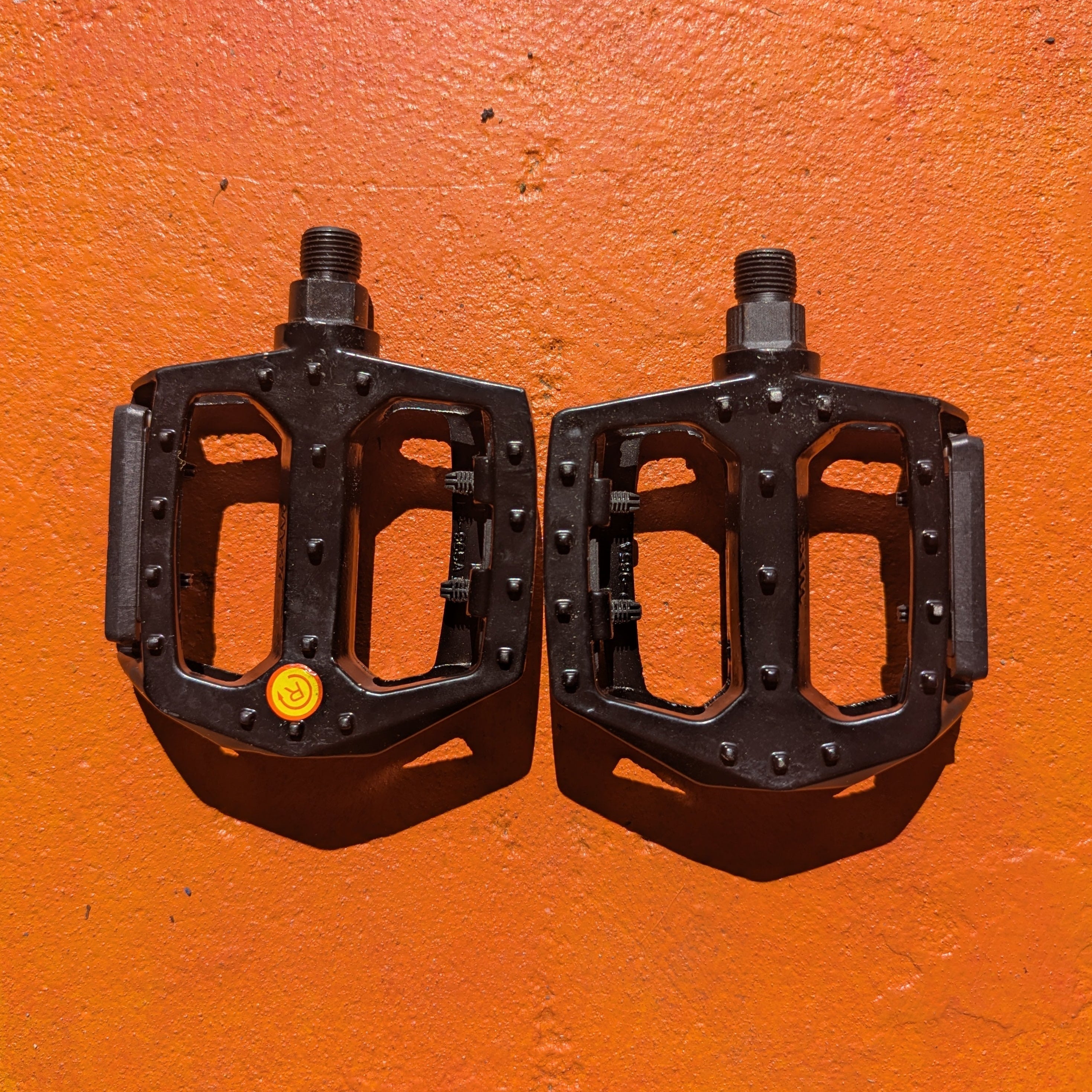 A pair of metal bicycle pedals in Style 3, featuring a sleek, modern design with textured surfaces for grip and a durable metallic finish.