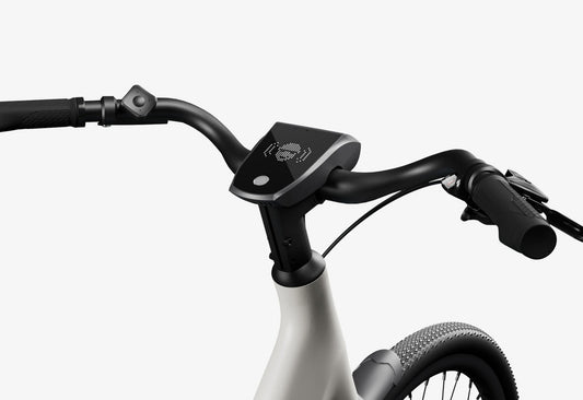 Side view of the Urtopia Carbon 1 Step Thru eBike in a modern setting, showcasing its lightweight carbon frame, step-through design, and integrated display.