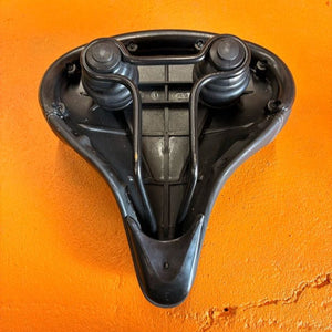 A black eBike seat in a beach cruiser style with a wide, cushioned design and visible stitching, shown against a white background.