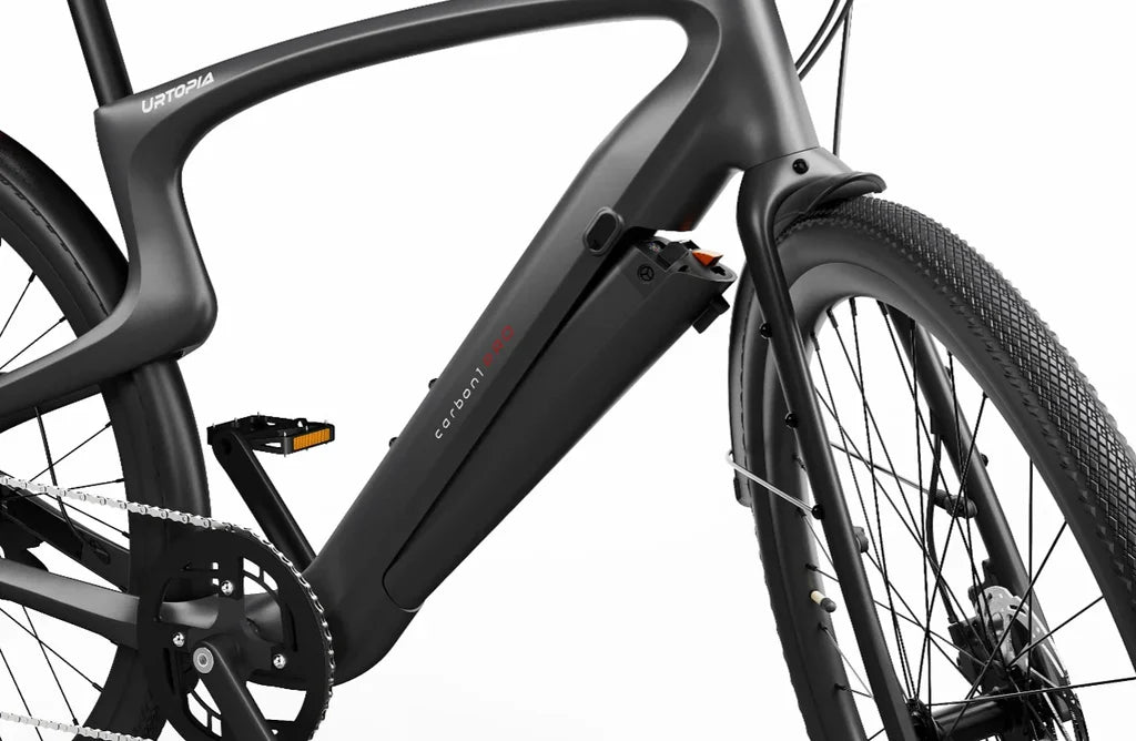 Side view of the Urtopia Carbon 1 Pro eBike in matte black, showcasing its lightweight carbon fiber frame, integrated display, and sleek, minimalist design against a white background.
