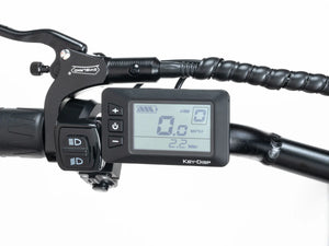 Alt text: Macfox X2 eBike display unit showing speed, battery level, and other ride information, mounted on handlebars.