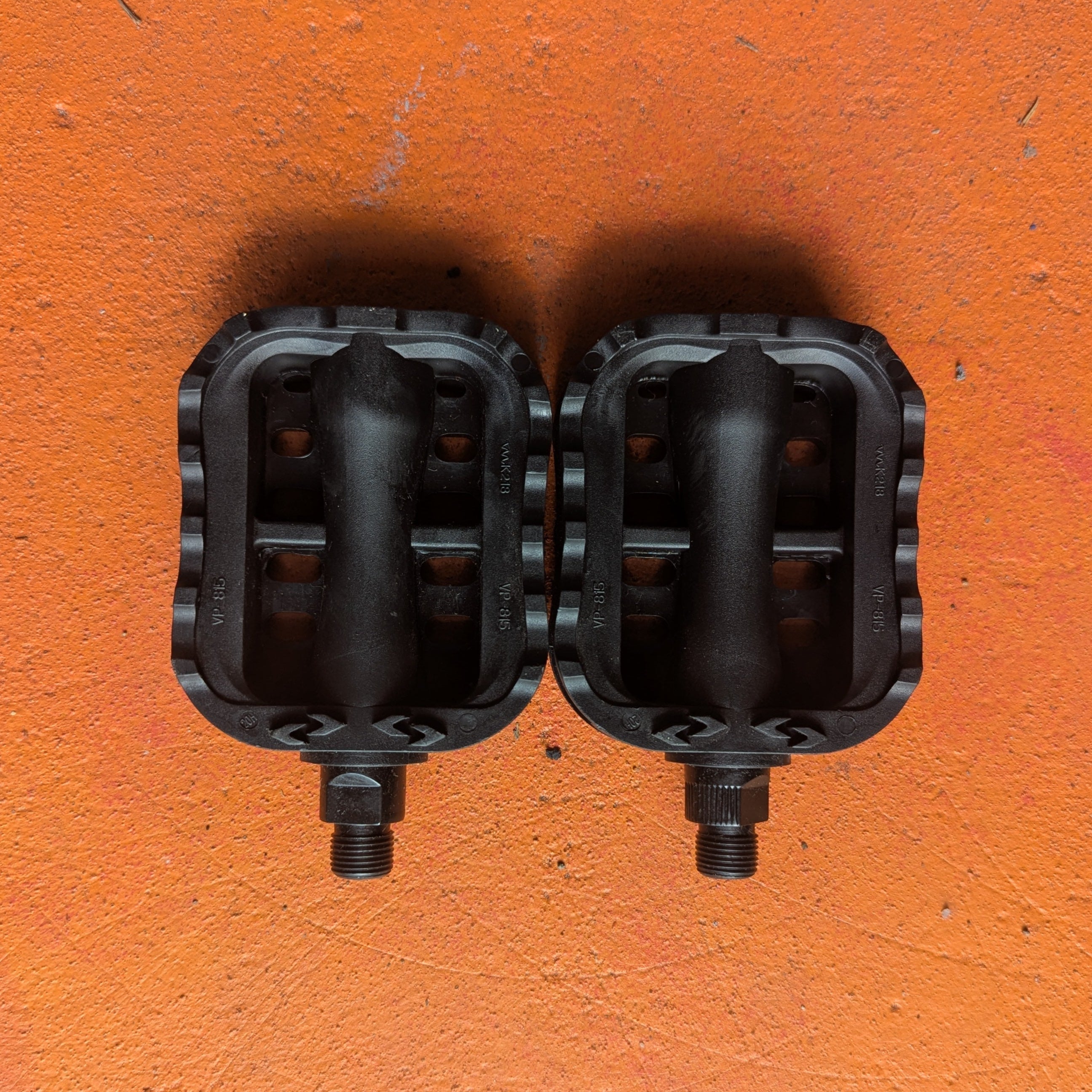 Close-up of metal eBike pedals in a beach cruiser style, showing textured surface and sturdy construction.