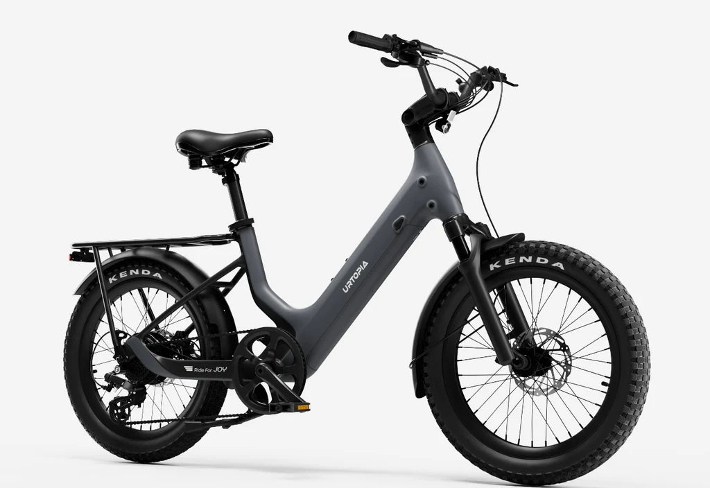 Side view of the Urtopia Carbon Joy eBike in charcoal gray, showcasing its sleek frame, integrated battery, and modern design against a plain background.