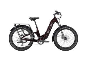 A black Velotric Nomad 2X eBike with fat tires, front suspension fork, integrated battery, and rear cargo rack, shown in a side profile against a white background.