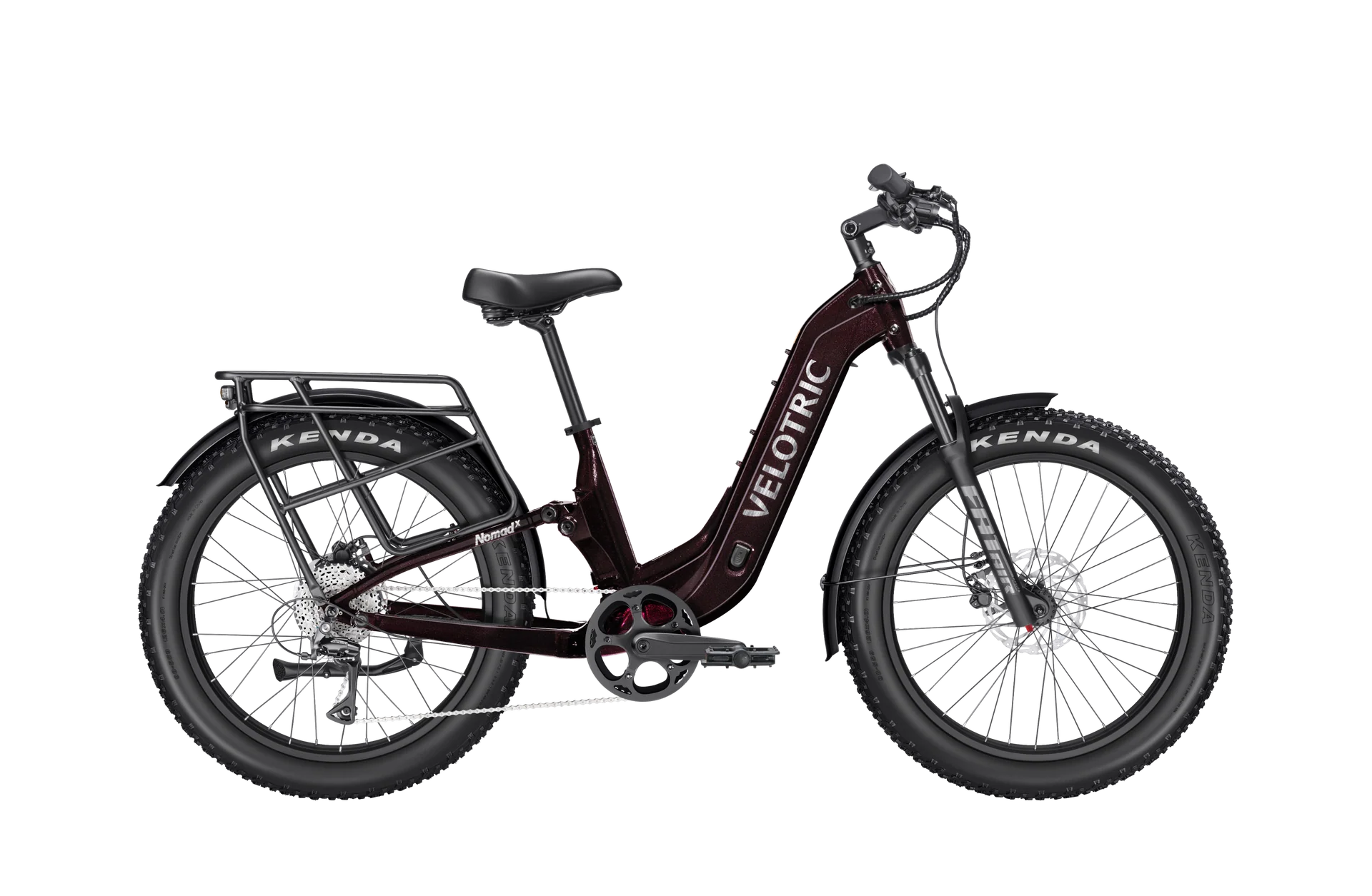 A black Velotric Nomad 2X eBike with fat tires, front suspension fork, integrated battery, and rear cargo rack, shown in a side profile against a white background.