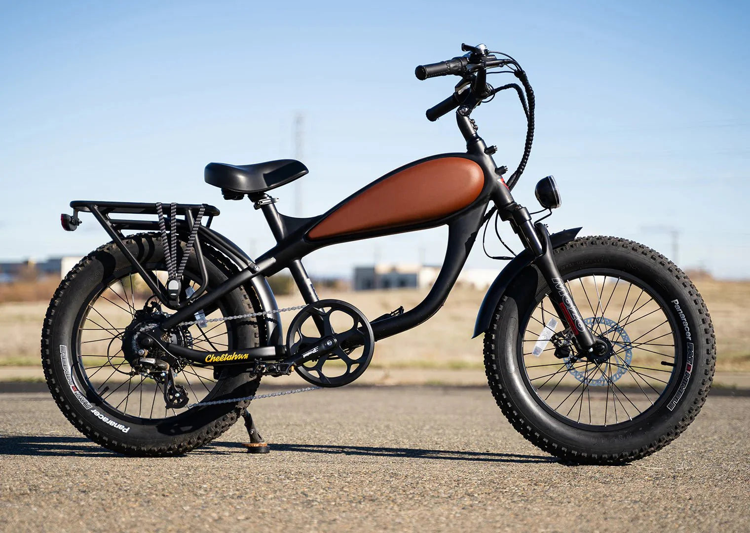 A vintage-style REVI Cheetah Mini 500w step-over electric bike with 20x4 fat tires, shown in a product image.
