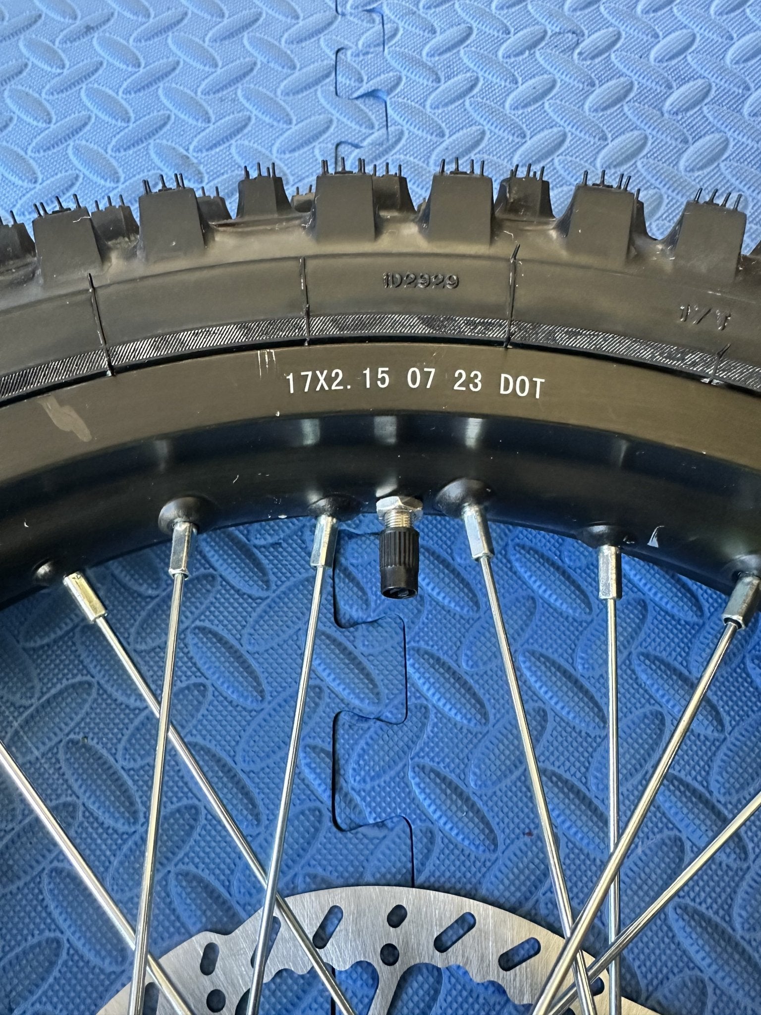 Alt text: Surron eMoto CST Knobby 17-inch front and rear wheel and tire set for electric dirt bikes, shown without rotor or sprocket.