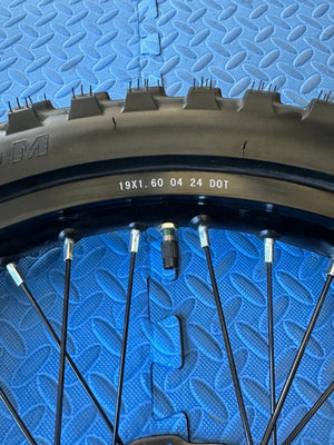 CST knobby 19-inch rear wheel and tire set for Surron eMoto electric dirt bikes, shown without rotor or sprocket.