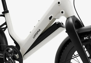 Side view of the Urtopia Carbon Joy Ultra eBike in a modern setting, showcasing its sleek carbon frame, integrated battery, and minimalist design.