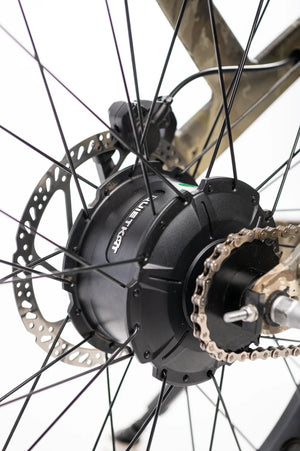 A QuietKat Ranger AWD 750w Step Over eBike with 26x4.5 fat tires, shown from the side on a mountain trail.