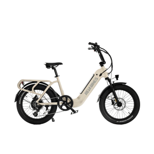 A white REVI Runabout 2 Step Thru electric bike with 20x3 fat tires, rear cargo rack, and 750w motor, shown from the side against a plain background.