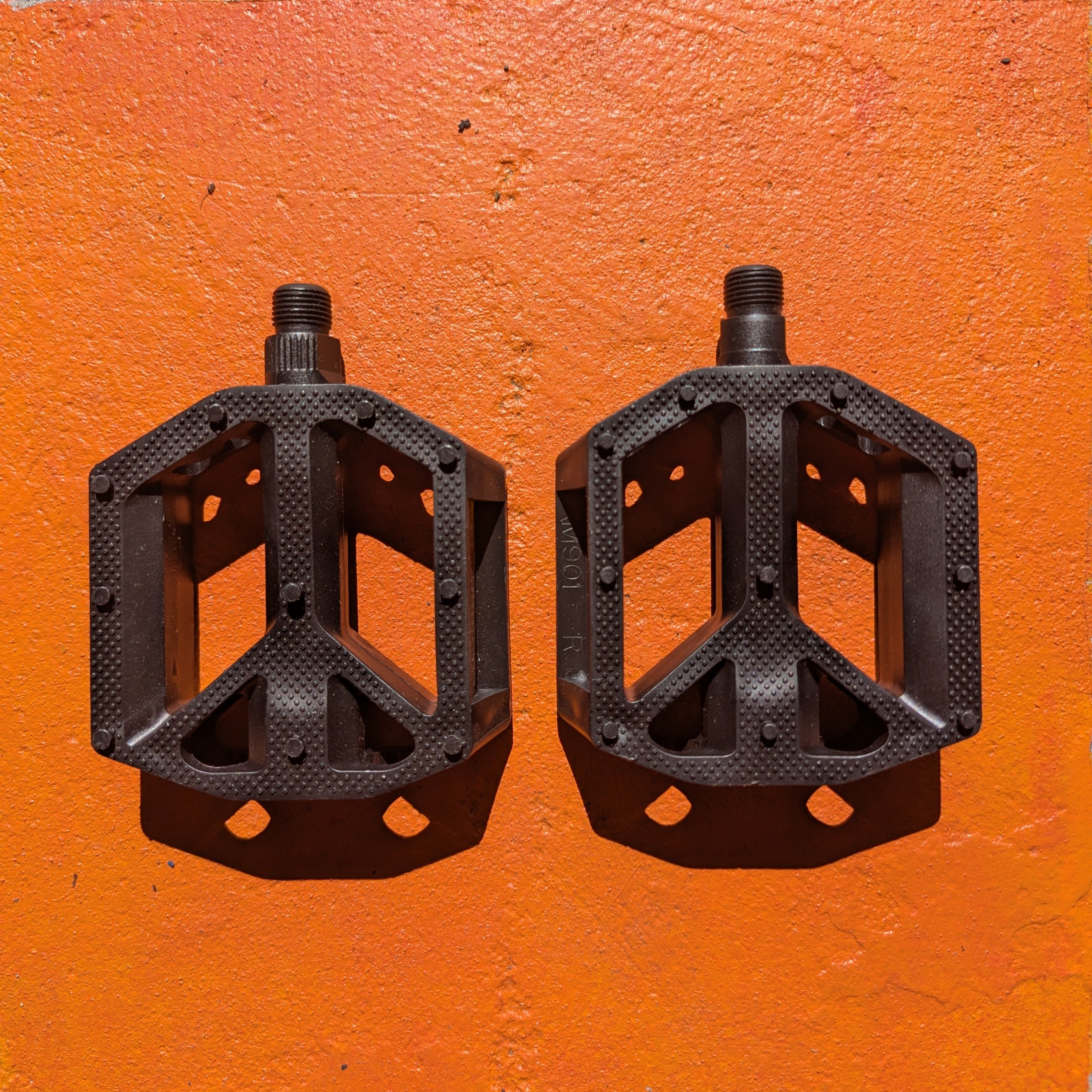 Black nylon eBike pedal with textured surface and reflectors, shown from a side angle on a white background.