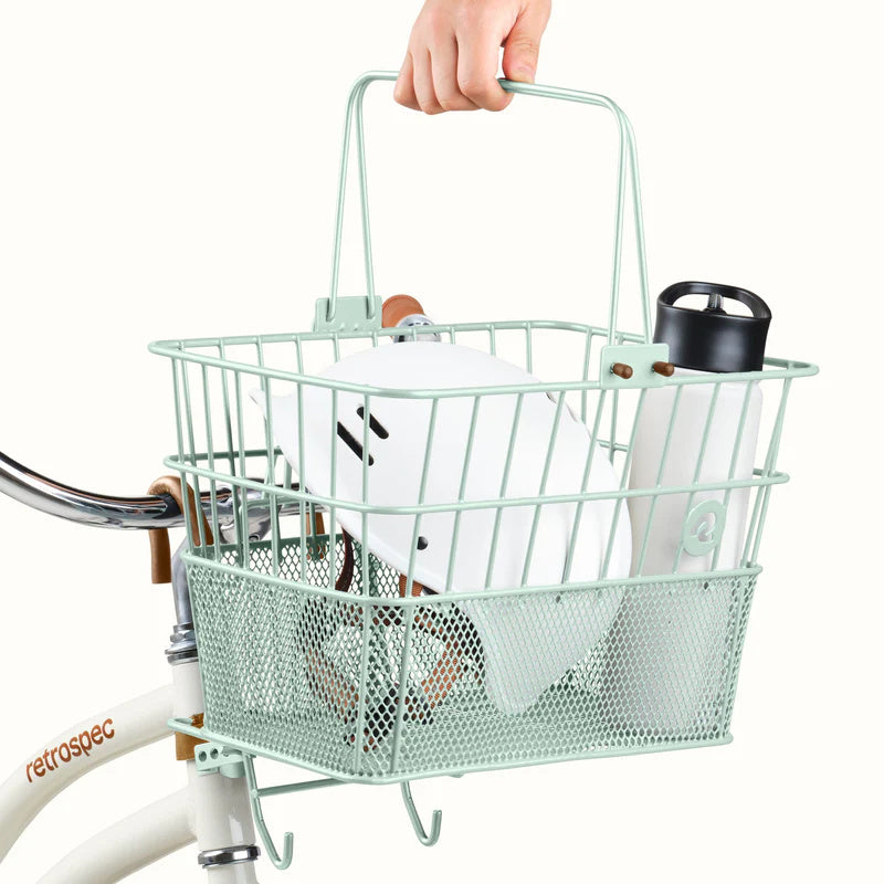 Retrospec Apollo steel bike basket in matcha green, attached to the front of an eBike