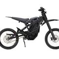 Side view of the eMOTO eRide Pro SS 2.0 electric dirt bike, featuring a rugged frame, 19x3 off-road tires, and a sleek black and red design.